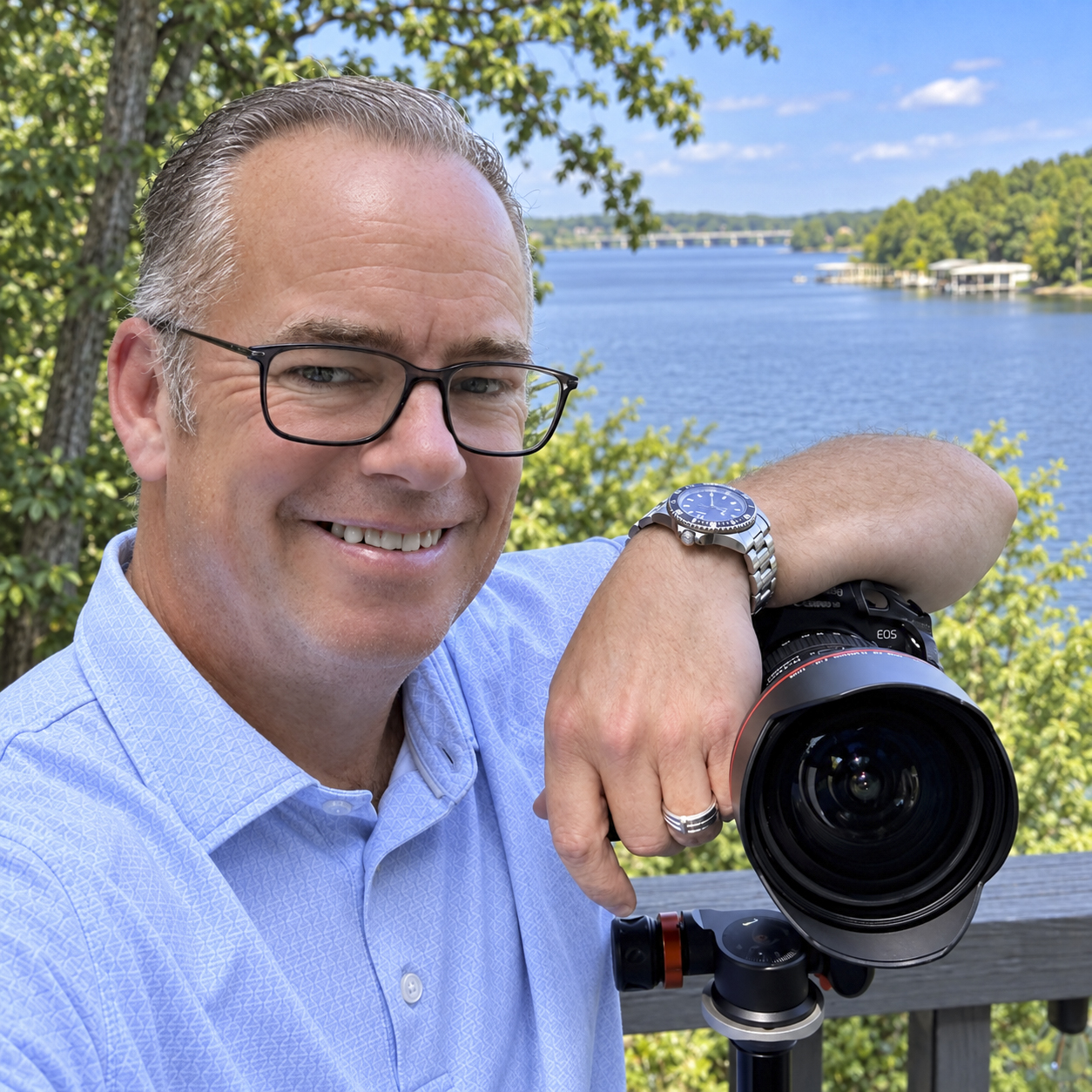 Founder of Elevated Visuals LLC with his camera overlooking a lake.