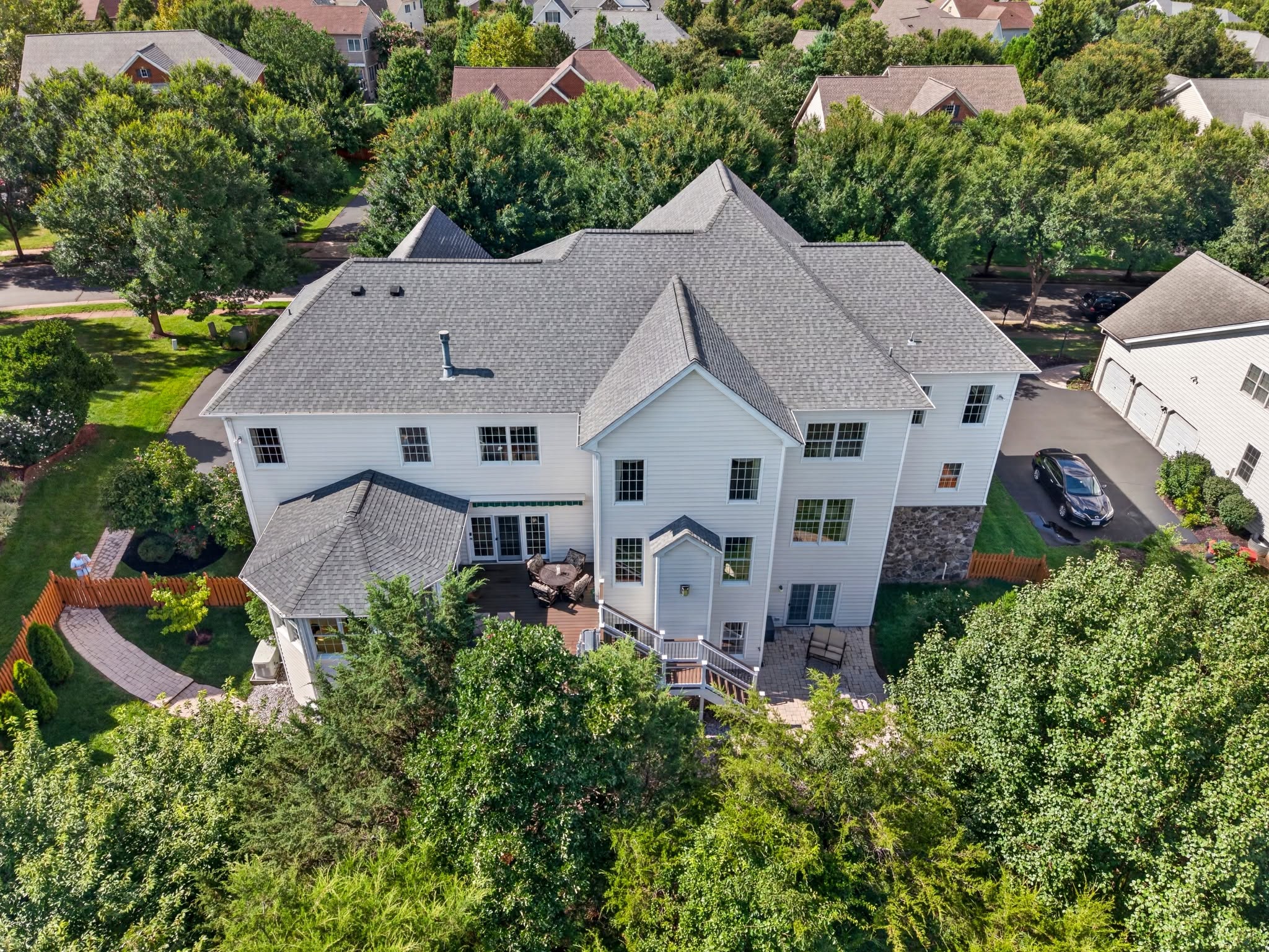 Aerial view of a home's rear elevation showing the deck and patio