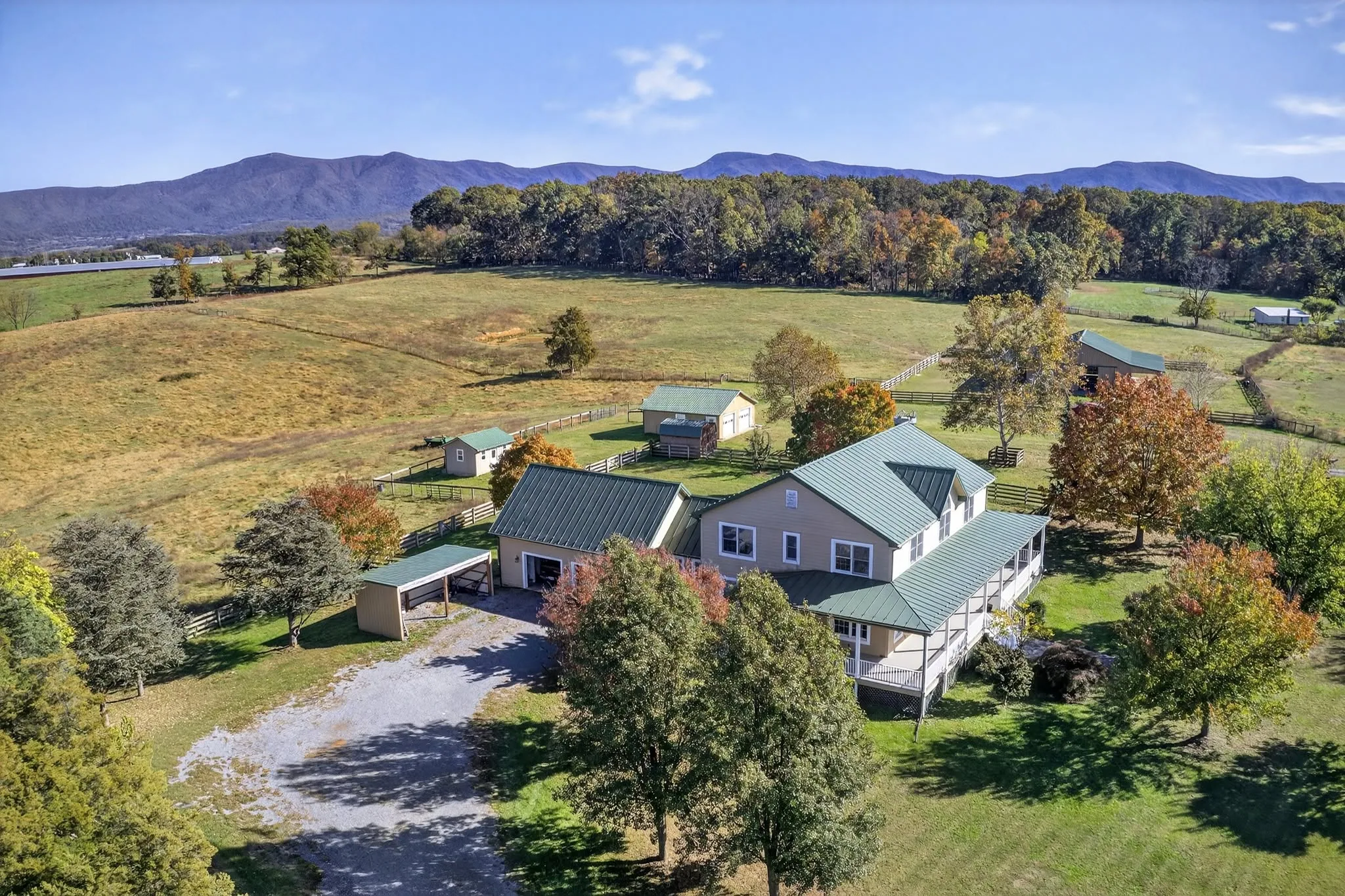 Aerial view of farmland and pasture with rolling mountains along the horizon