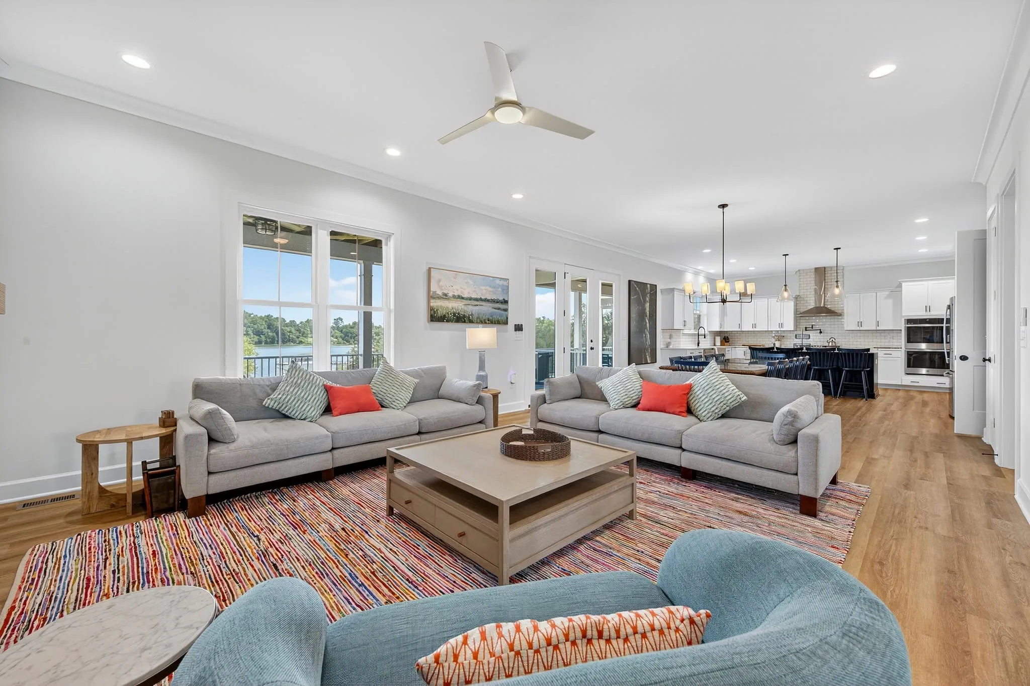 Open living room with sectional seating and a coffee table looking through to the kitchen