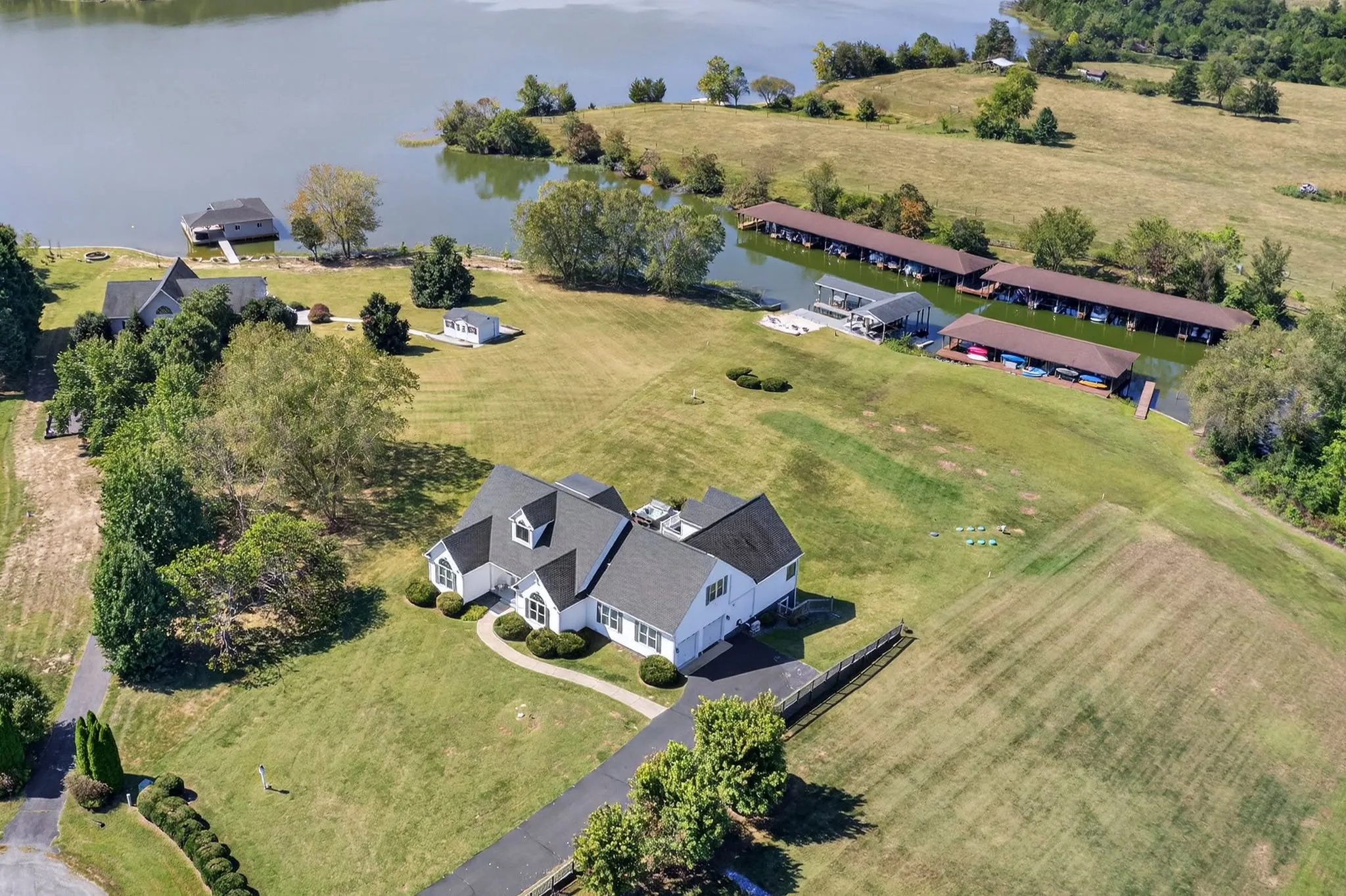 Aerial view of a lakefront home with its own dock and shoreline frontage